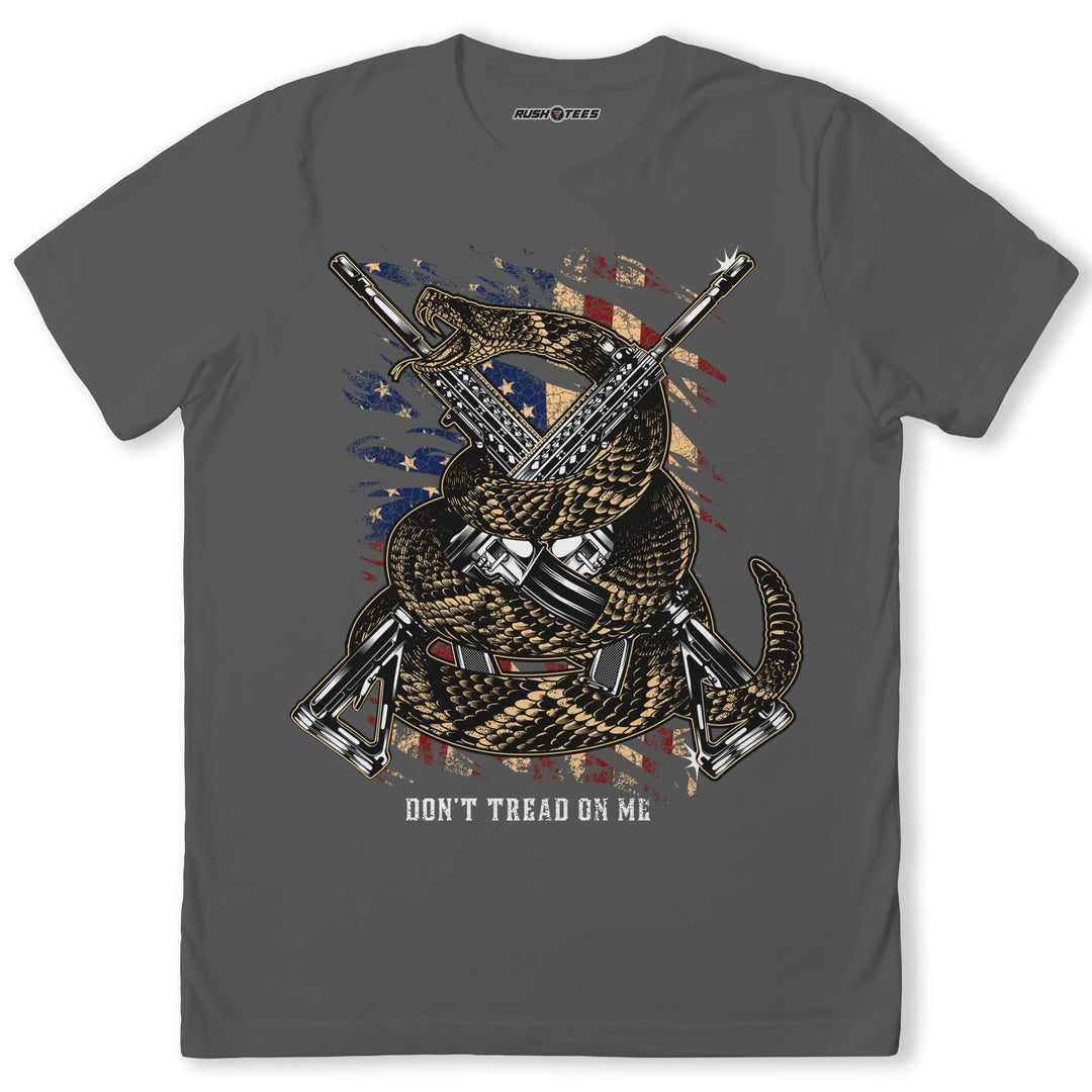 Don't Tread on Me t-shirt featuring a coiled rattlesnake and rifles on distressed American flag background.