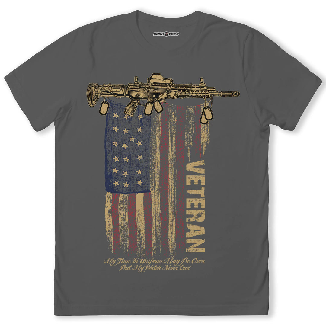 VETERAN AR FLAG T-shirt with assault rifle graphic over distressed American flag, honoring military service and patriotism.