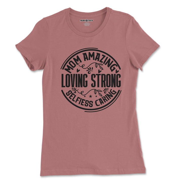 Pink graphic t-shirt featuring the words 'Mom Amazing Loving Strong Selfless Caring', perfect for Mother's Day gifts.