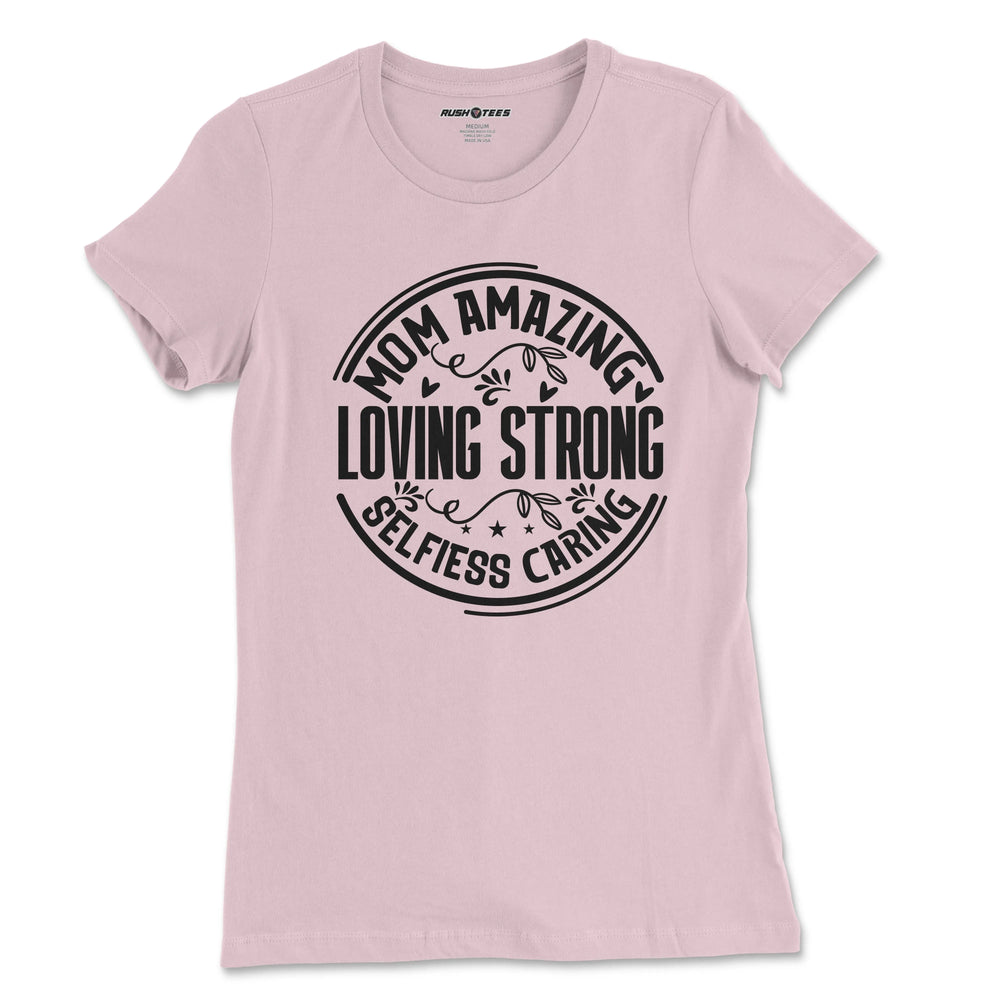 Pastel pink t-shirt featuring bold typography: 'Mom Amazing Loving Strong Selfless Caring', ideal for Mother's Day gifts.