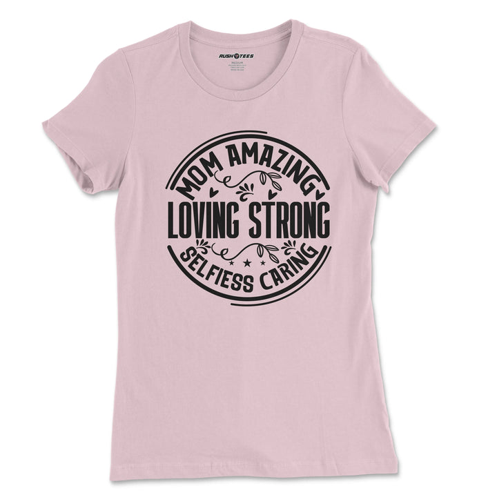 Pastel pink t-shirt featuring bold typography: 'Mom Amazing Loving Strong Selfless Caring', ideal for Mother's Day gifts.